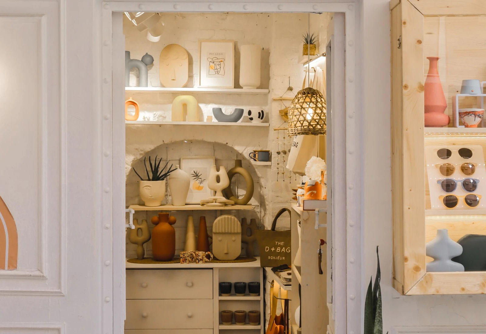 Home decor boutique display with ceramic objects, vases, planters and small accessories
