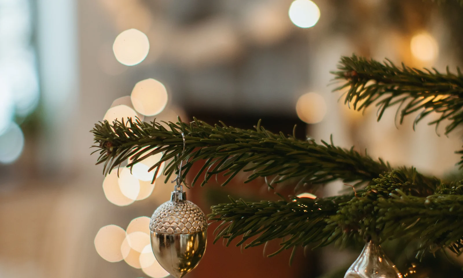 Close view of a reflective Christmas bauble hanging from a tree