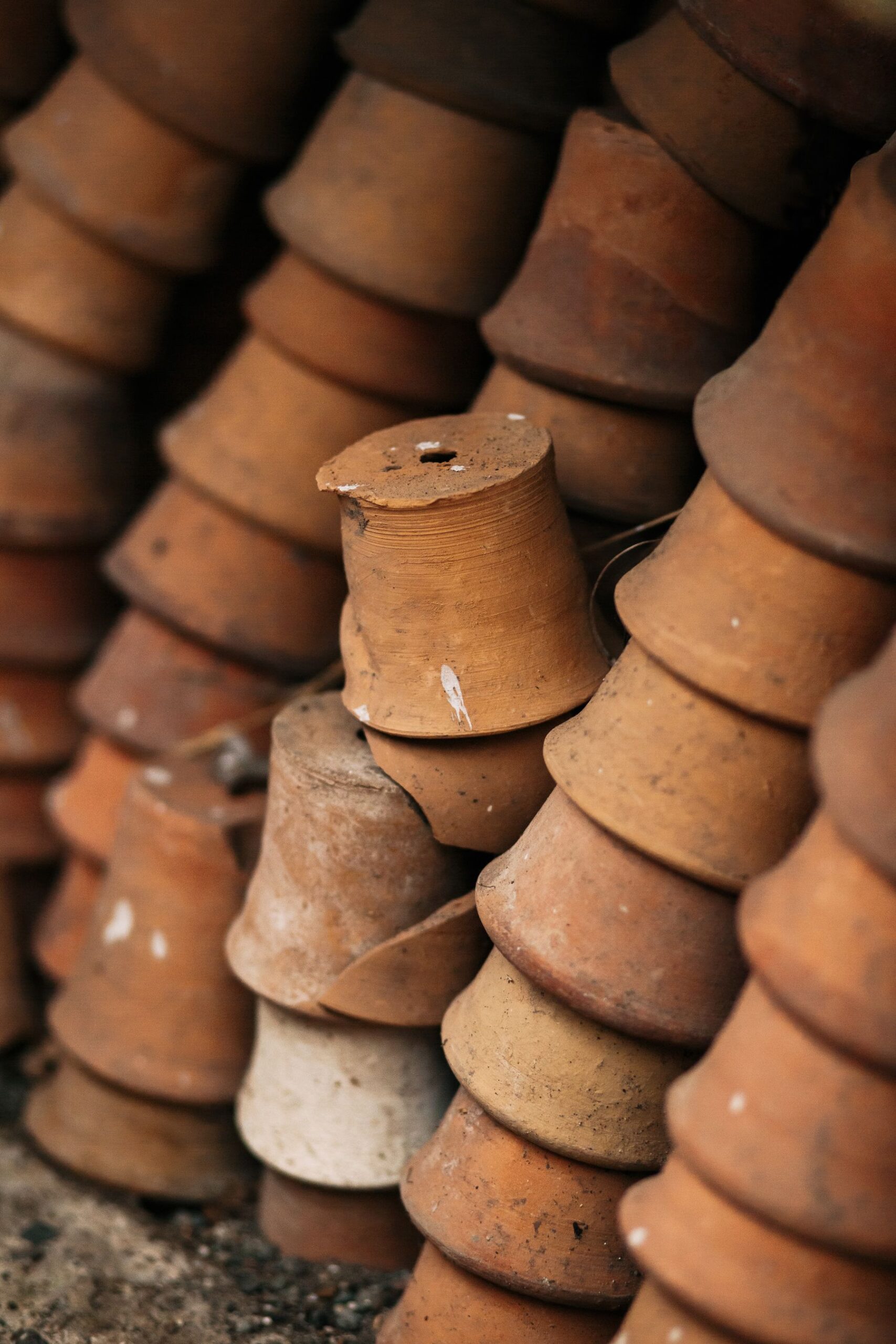 Real terracotta plant pots stacked with rims and finished surfaces touching