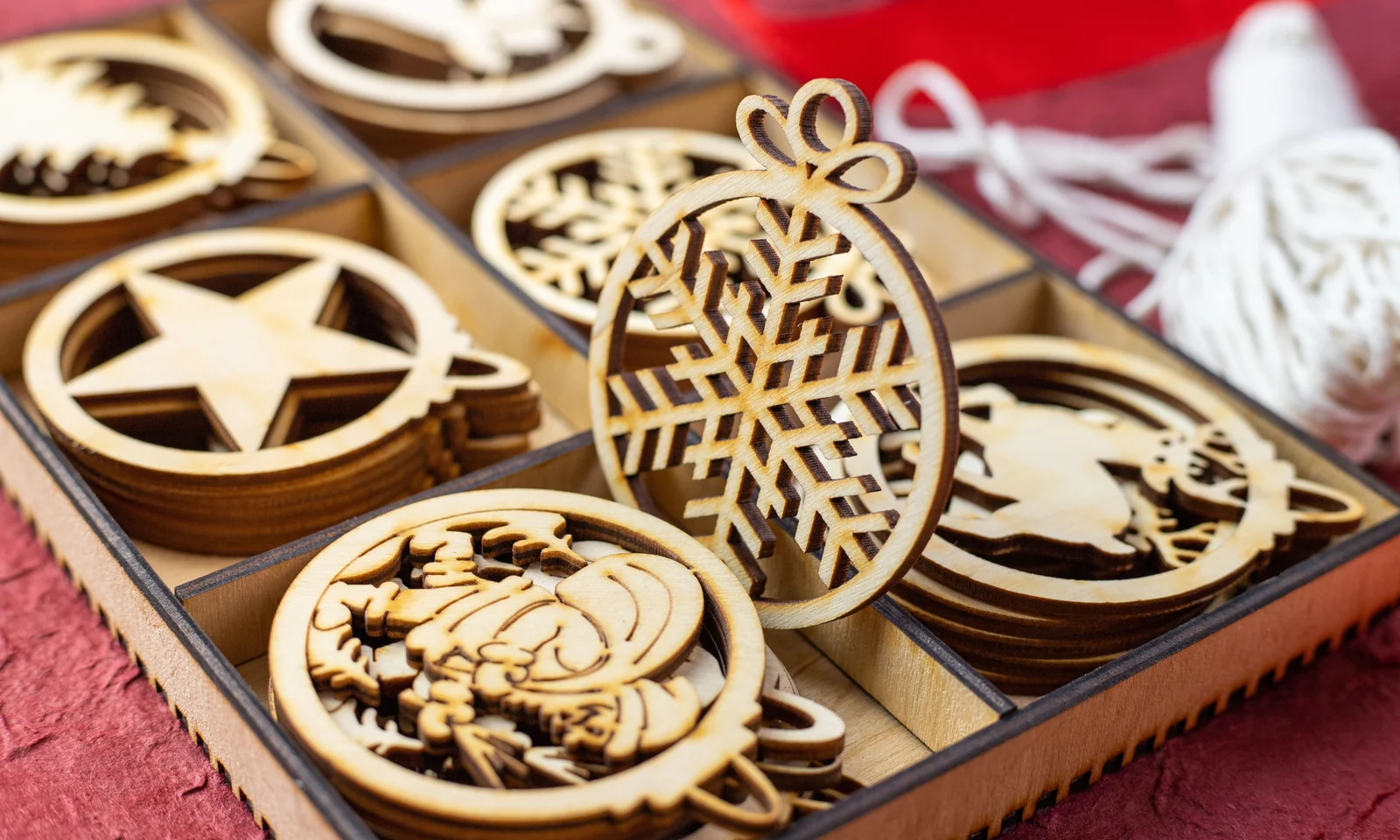 Wooden Christmas ornament shapes arranged in a box