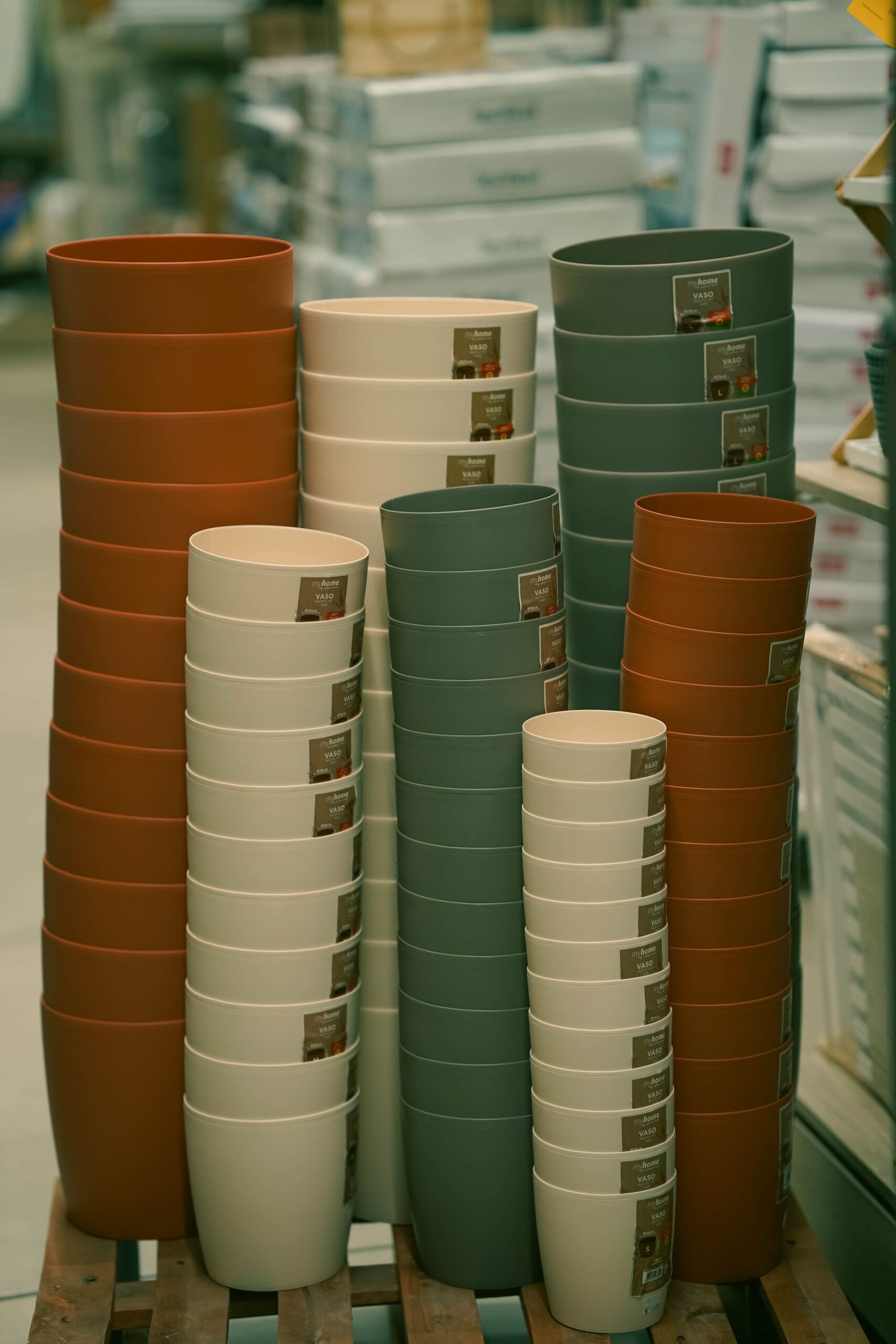 Stacked plant pots in repeated colours and sizes in a store display
