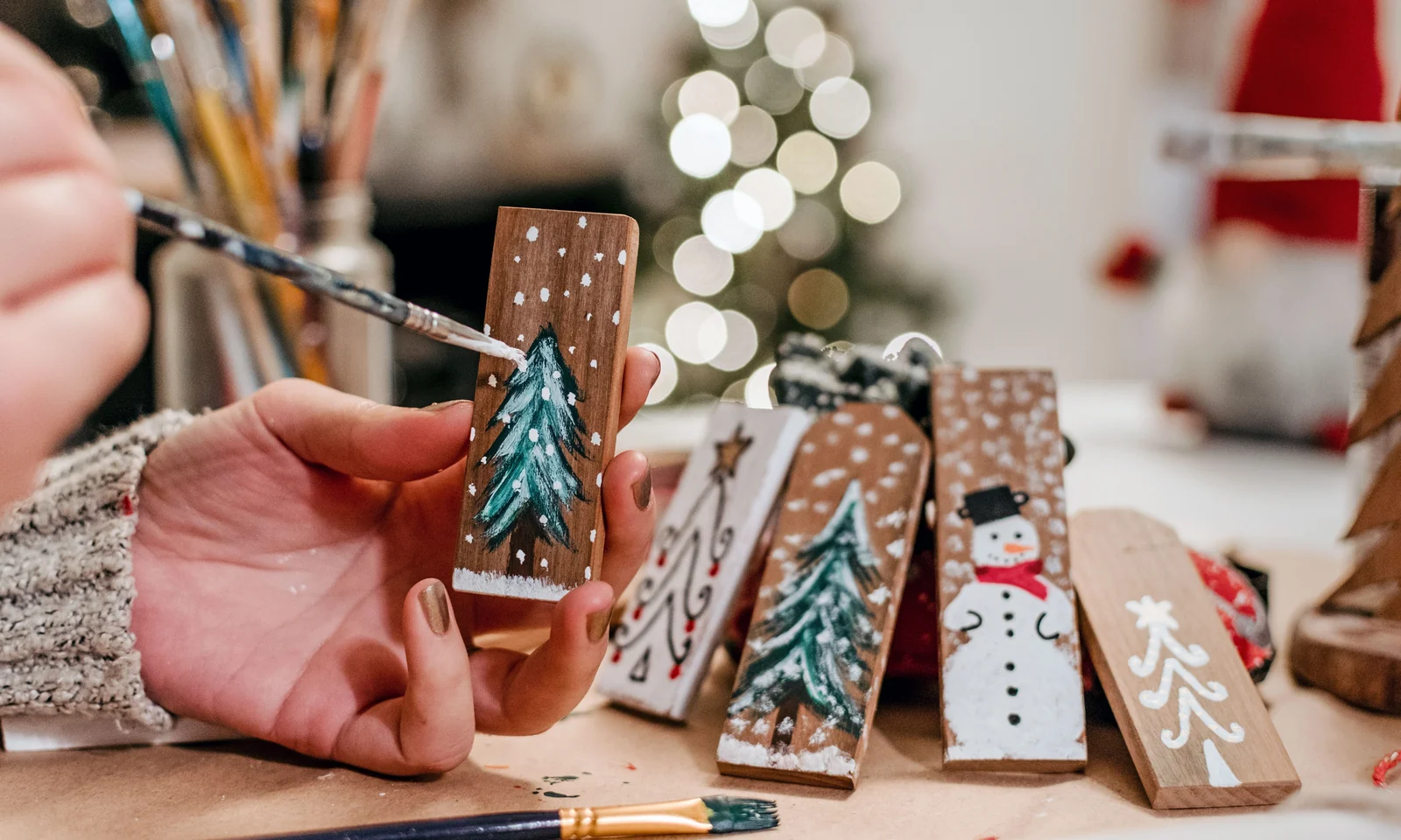 Hands painting custom wooden Christmas ornaments
