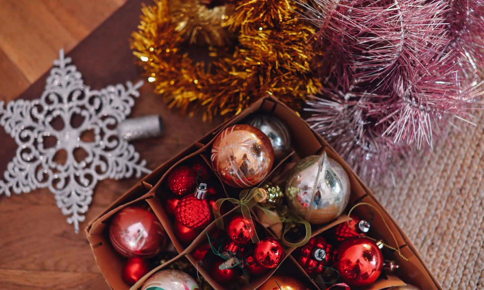 Colourful Christmas ornaments arranged together in a storage box